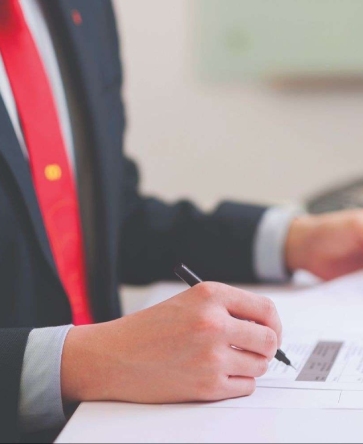 AmBanker with pen signing